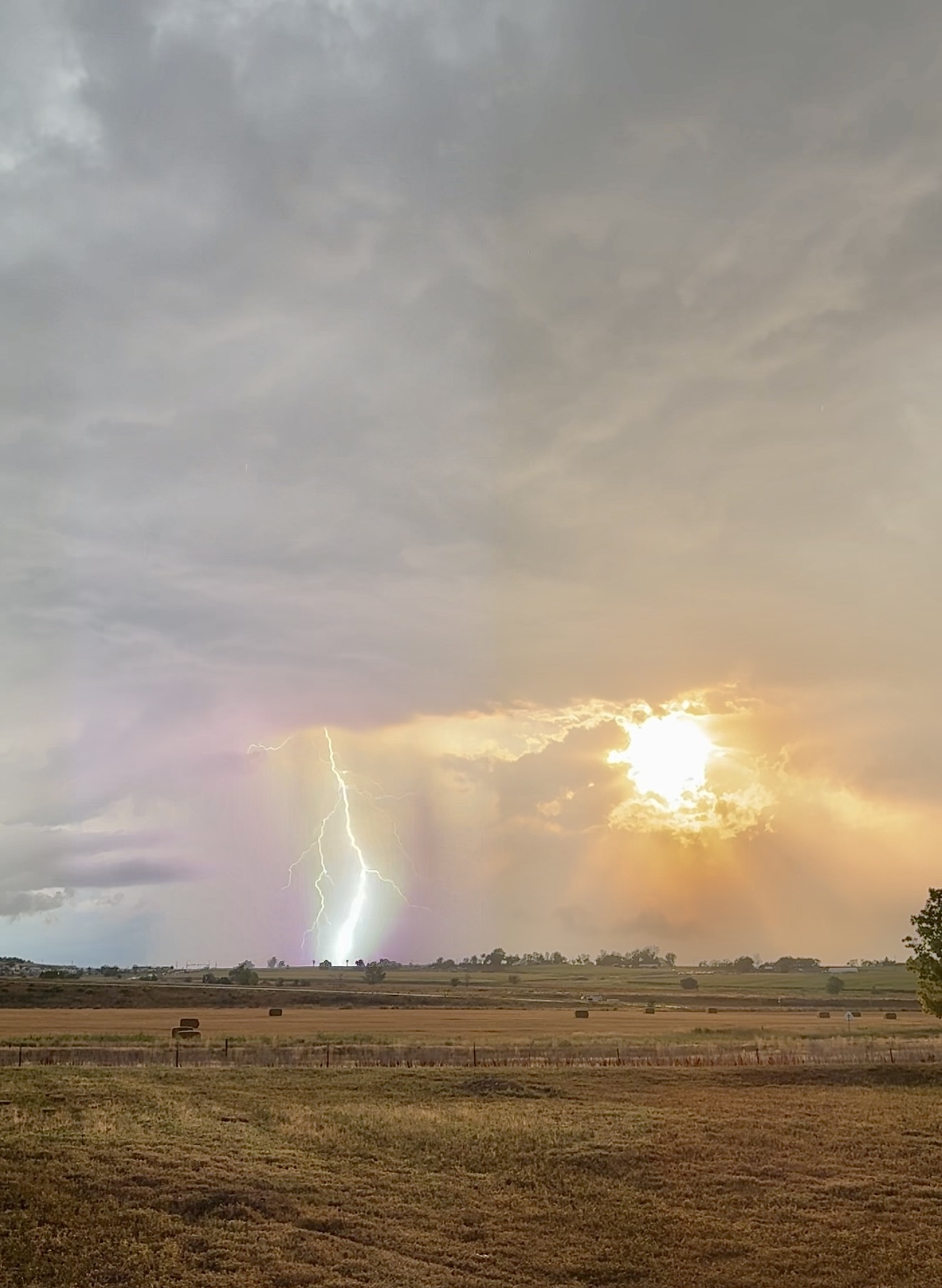 Lightning beneath a glowing sunset
